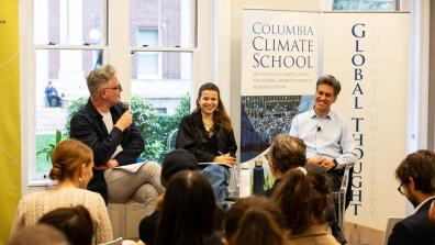 Luisa Neubauer, Ed Miliband, and Adam Tooze address the room during a roundtable event