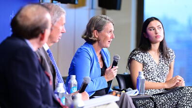 Panelists speak during the State of the World conference