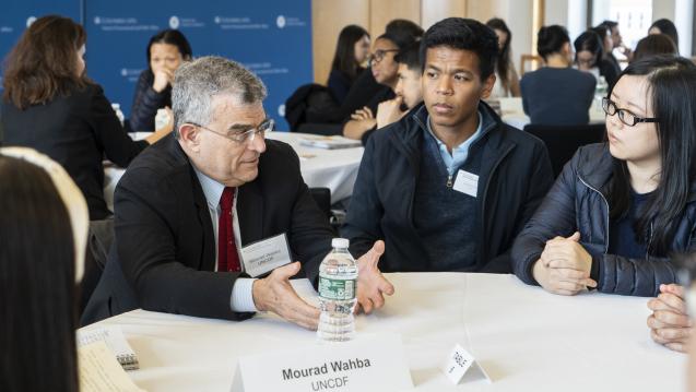 people speaking around a table