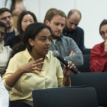 student speaking into microphone