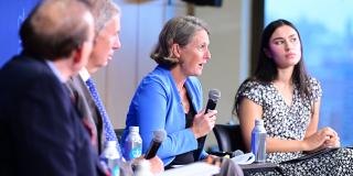 Panelists speak during the State of the World conference