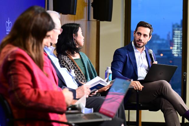 Panelists engage in discussion at the State of the World Conference